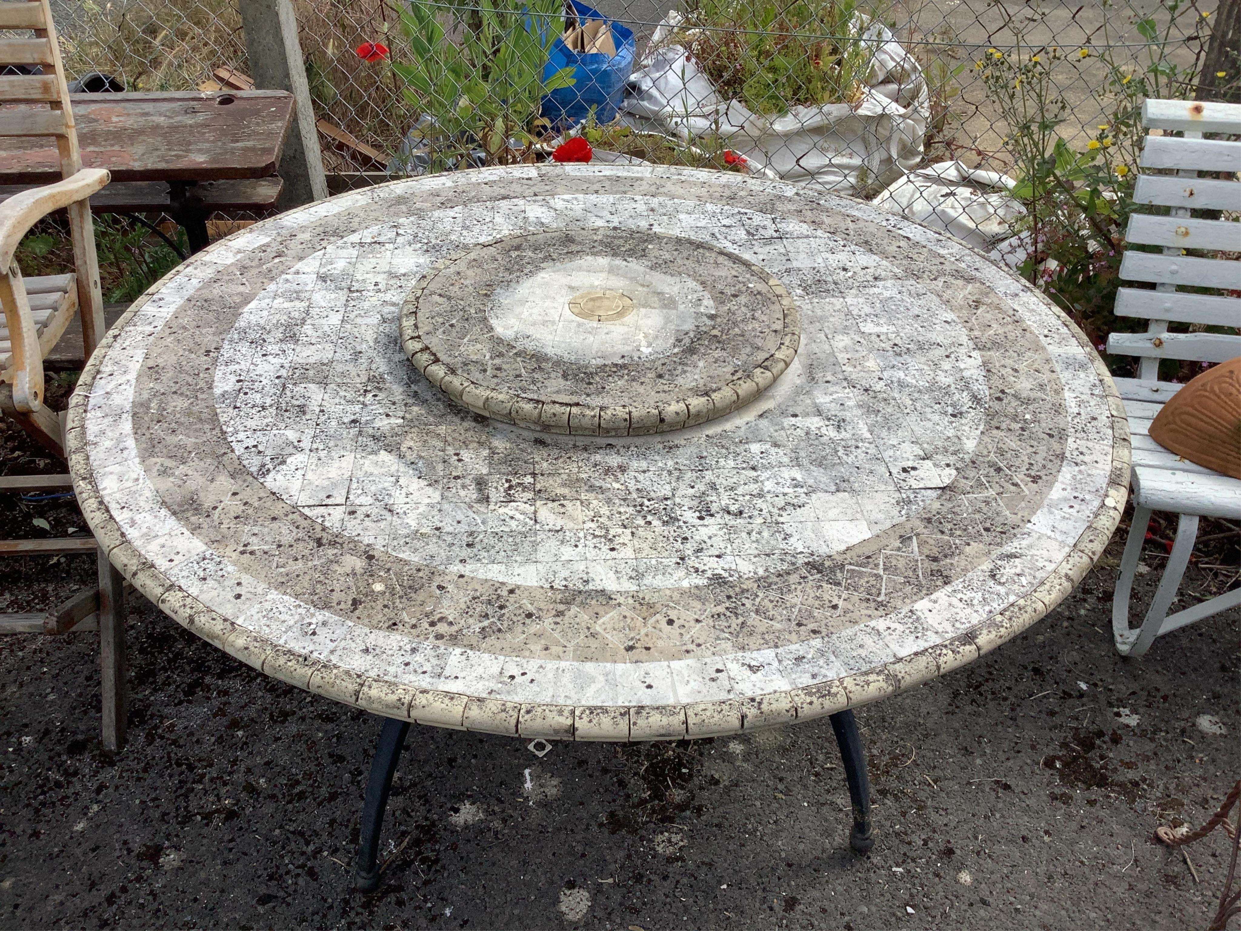 A circular mosaic stone garden table with 'Lazy Susan', diameter 150cm, height 74cm. Condition - fair